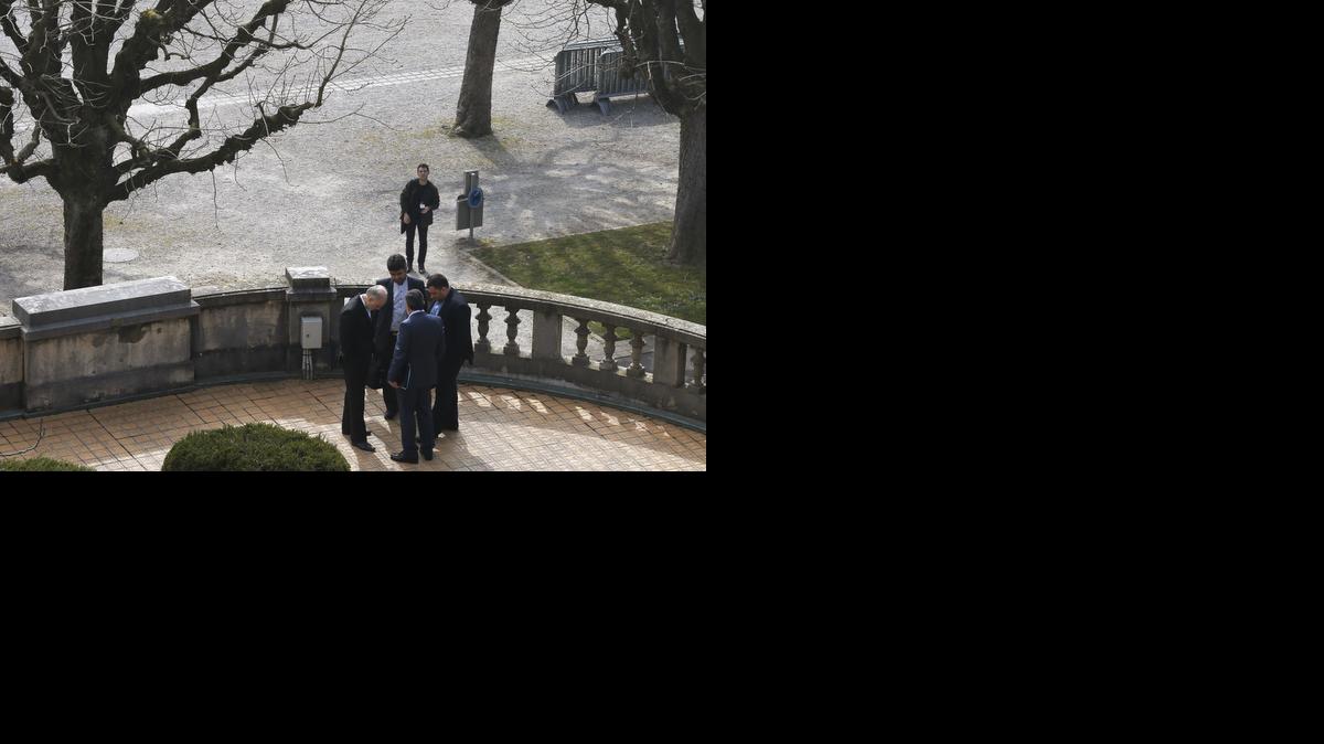 
Iran's nuclear chief Ali Akbar Salehi, left, and other Iranian negotiators talk in private outside the Beau-Rivage hotel, following a meeting between U.S. Secretary of State John Kerry and Iran's Foreign Minister Javad Zarif 

