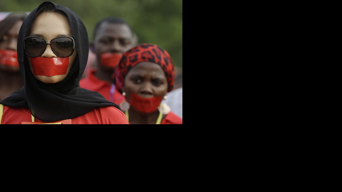 
People march during a silent protest calling on the government to rescue the kidnapped girls of the government secondary school in Chibok, who were abducted a year ago, in Abuja, Nigeria
