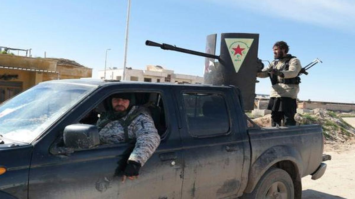 
In this image posted on a militant social media account by the Al-Baraka division of the Islamic State group on Tuesday, Islamic State militants rode in a Kurdish popular protection unit (YPG) vehicle captured during fighting in Tal Tamr, Hassakeh province, Syria. 
