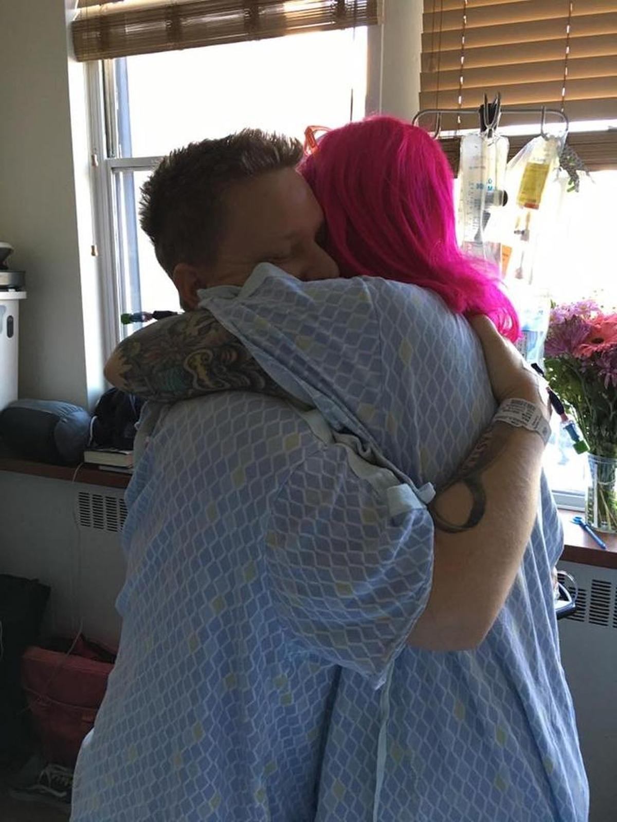 Royals fan Josh Harrold, left, hugs Giants fan Kelly van den Berghe after he donated one of his kidneys to her on Wednesday.
