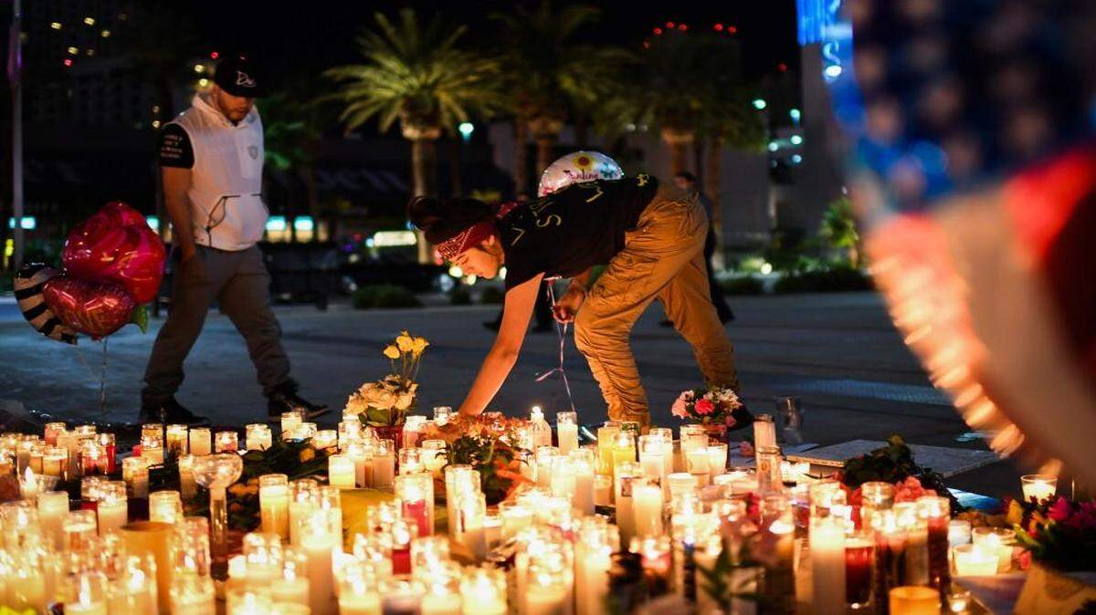Priscilla Olivas lighted a candle at a street vigil along the Las Vegas Strip on Monday.