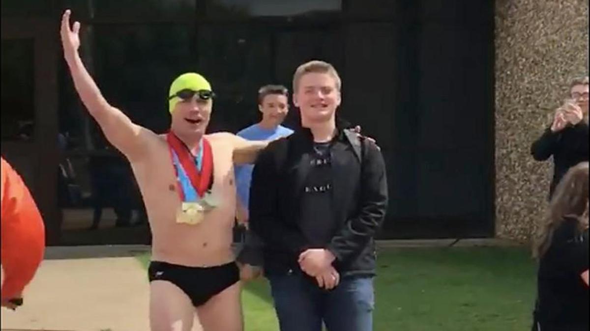 Justin Beadles picked up his 15-year-old son on the last day of school dressed like Olympic swimmer Michael Phelps.