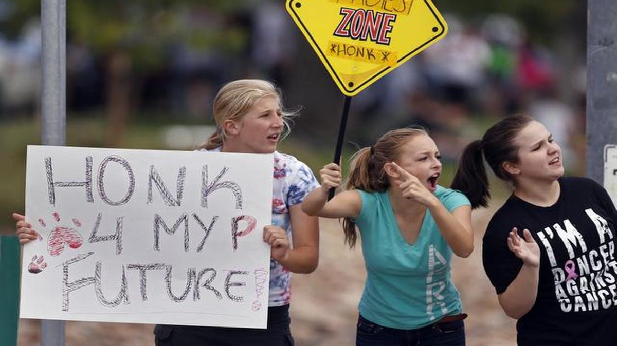 
In this Sept. 23 photo, protesting Pamona High School students engaged with passing motorists at a busy intersection near their school.
