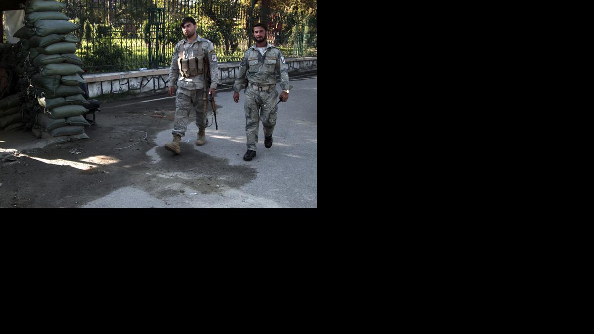 
Afghan policemen patrol at the site of a deadly attack by an Afghan national army soldier who opened fire on U.S. troops
