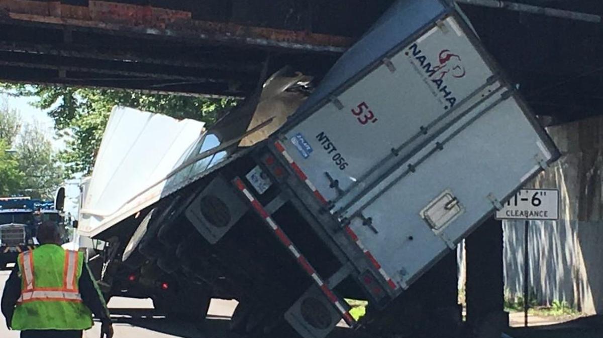 The driver of this semi-truck hit a bridge and got stuck under it on his first day on the job Tuesday in western New York.