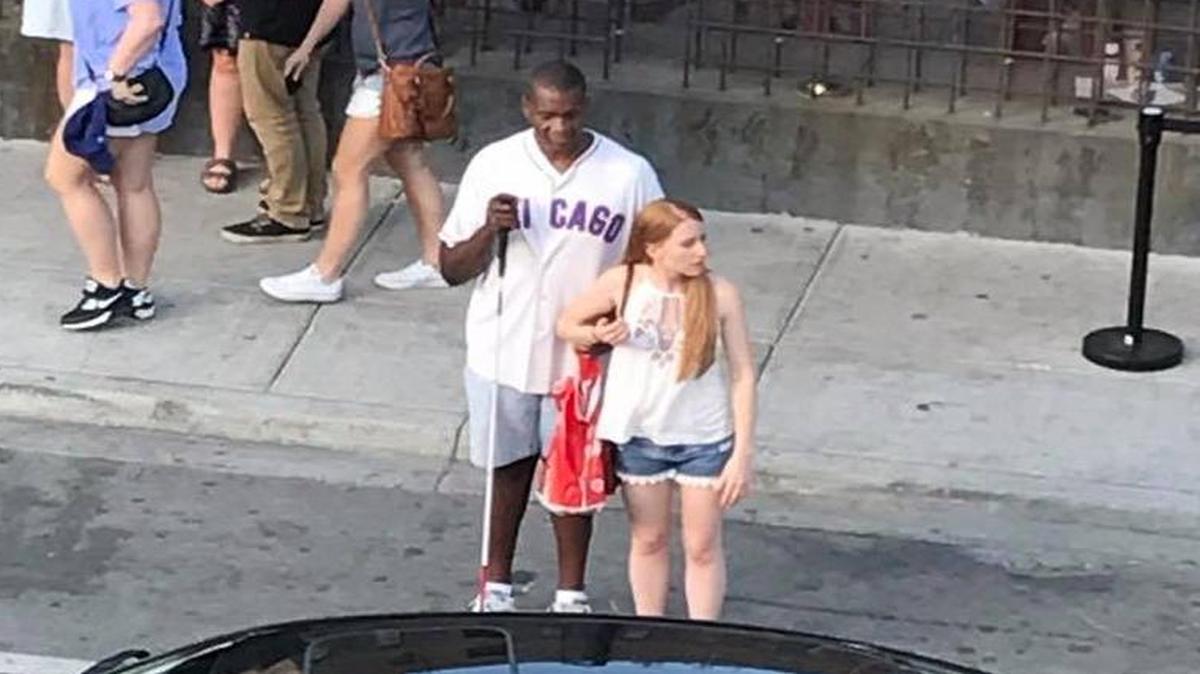A young woman who helped a blind Chicago Cubs fan hail a cab over the weekend has become a viral star after a stranger photographed the good deed and posted it on Facebook.