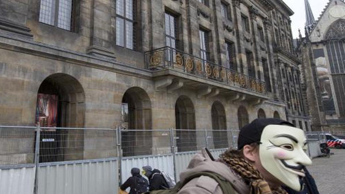 
A demonstrator wears an Anonymous mask during a protest rally outside the Royal Palace in Amsterdam, Netherlands, Wednesday, Nov. 5, 2014. If you're caught short on Amsterdam's historic Dam Square, the Dutch government has a message for you: Don't pee on the palace. 
