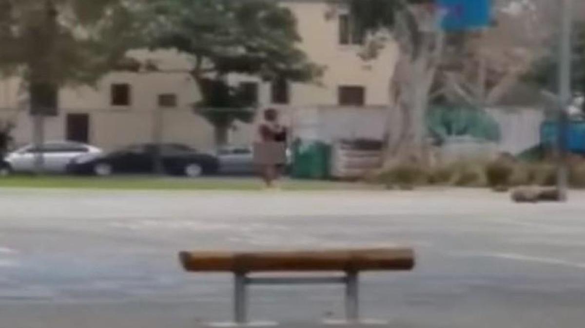A screengrab from a video shows a teacher (center) who allegedly chased elementary students on a playground while naked.