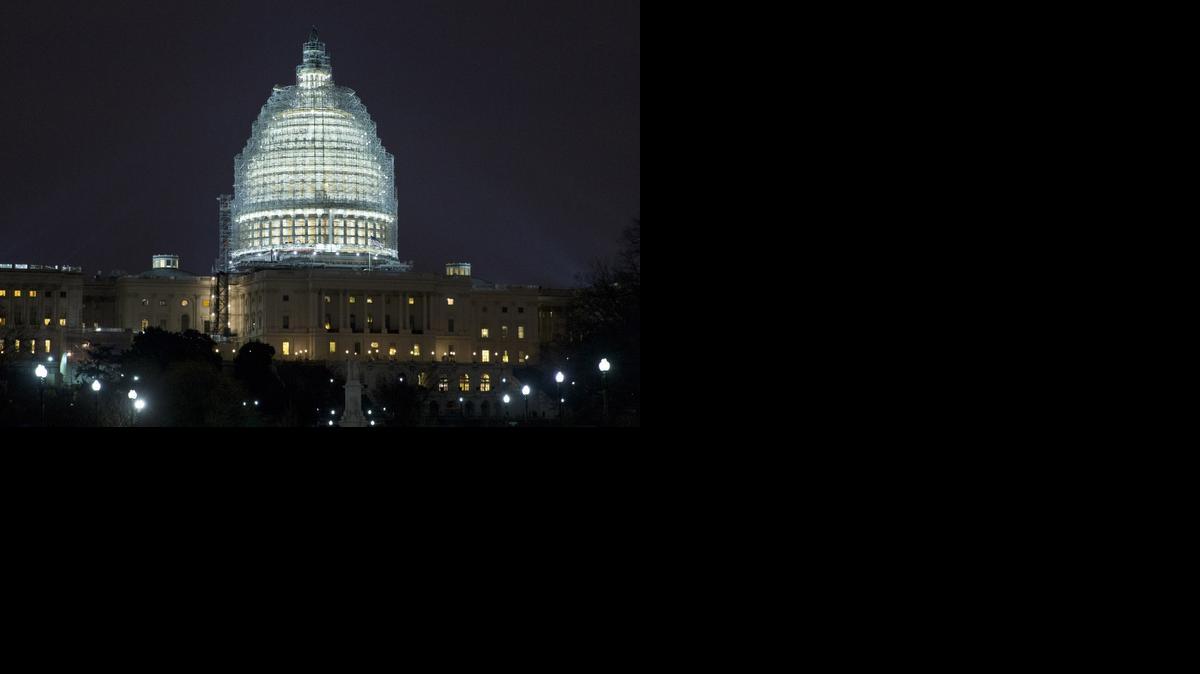 
Lights illuminate the U.S. Capitol, which is covered in scaffolding for restoration, in Washington Wednesday
