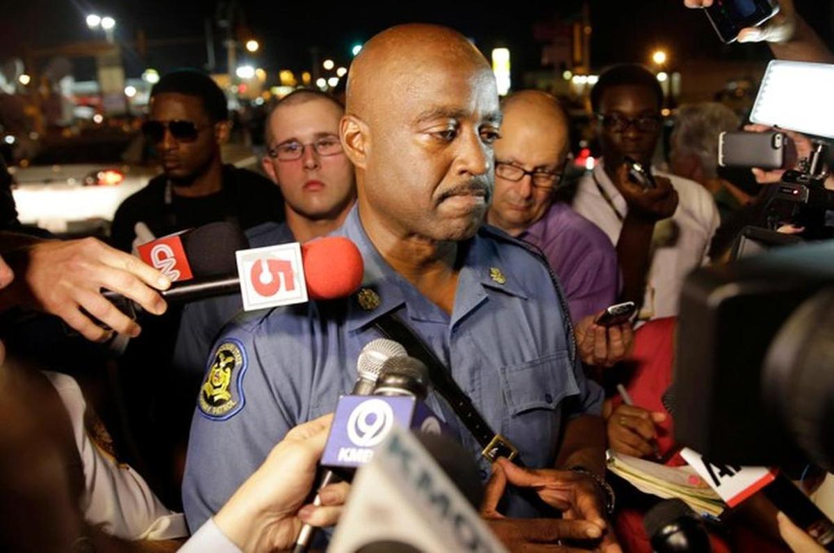 Capt. Ron Johnson of the Missouri Highway Patrol is surrounded by media after meeting with protesters Monday, Aug. 18, 2014, in Ferguson, Mo. The Aug. 9 shooting of Michael Brown by a police officer has touched off rancorous protests in Ferguson, a St. Louis suburb where police have used riot gear and tear gas. 