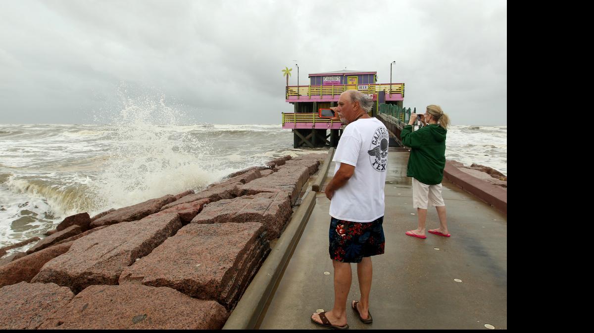 
Darrell Mayo shoots video of the rough surf from Tropical Storm Bill on Tuesday at Galveston's 61st Street Fishing Pier 
