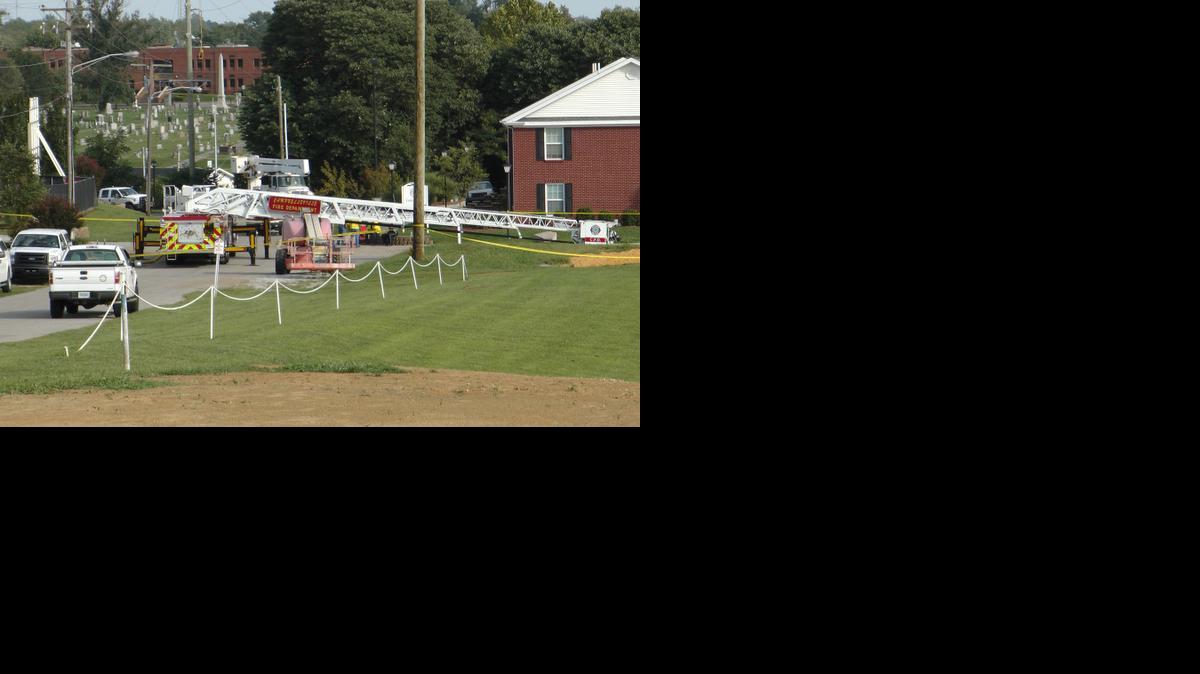 
A Campbellsville Fire Department truck with the ladder extended remained at the scene where two firefighters were injured during an ice bucket challenge 
