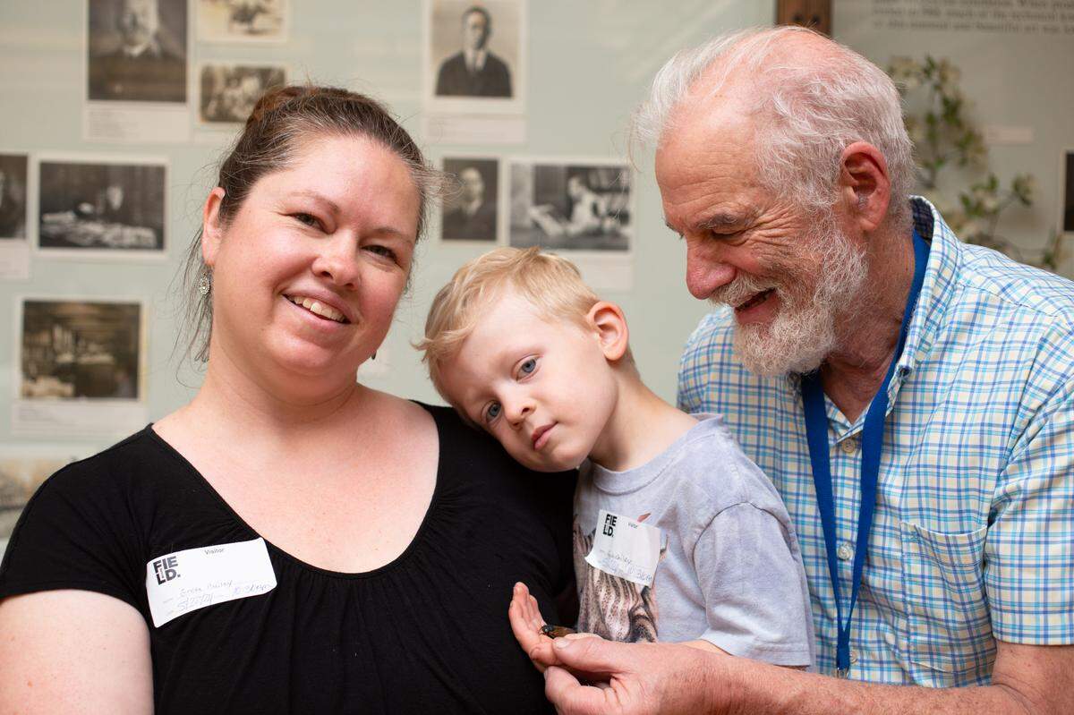 Jack Bailey, center, pictured with his mother, Greta Bailey, discovered the blue-eyed cicada. It’s the first blue-eyed cicada Field Museum collections assistant Jim Louderman, right, has ever seen.