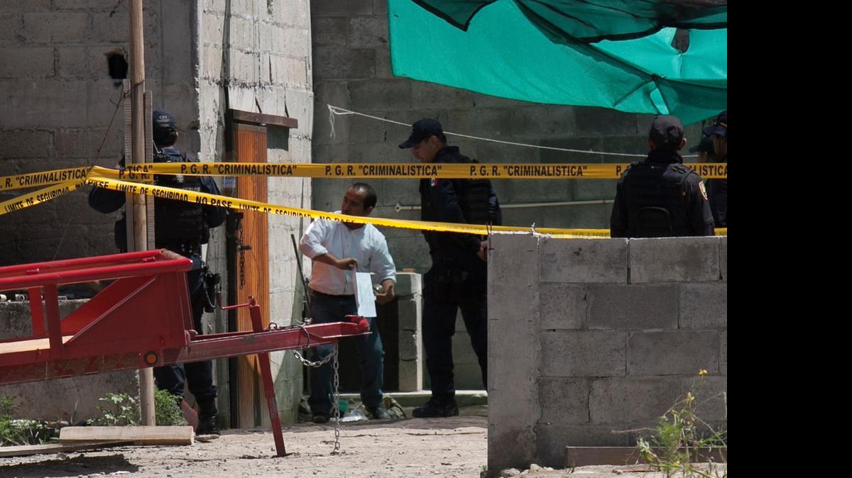 
Authorities investigate a half-built house near the Altiplano maximum security prison in Almoloya, west of Mexico City, Monday
