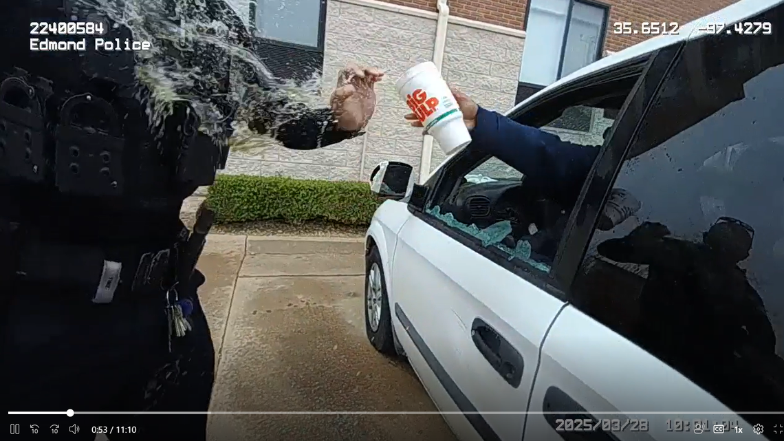 The woman splashed police with urine after an officer broke a window with a baton, body camera video shows.