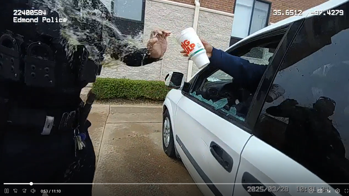 The woman splashed police with urine after an officer broke a window with a baton, body camera video shows.