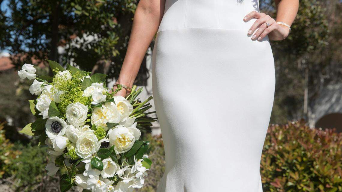 A wedding photographer is accused of secretly recording a bride, not the one pictured, as she was partially naked, authorities say.