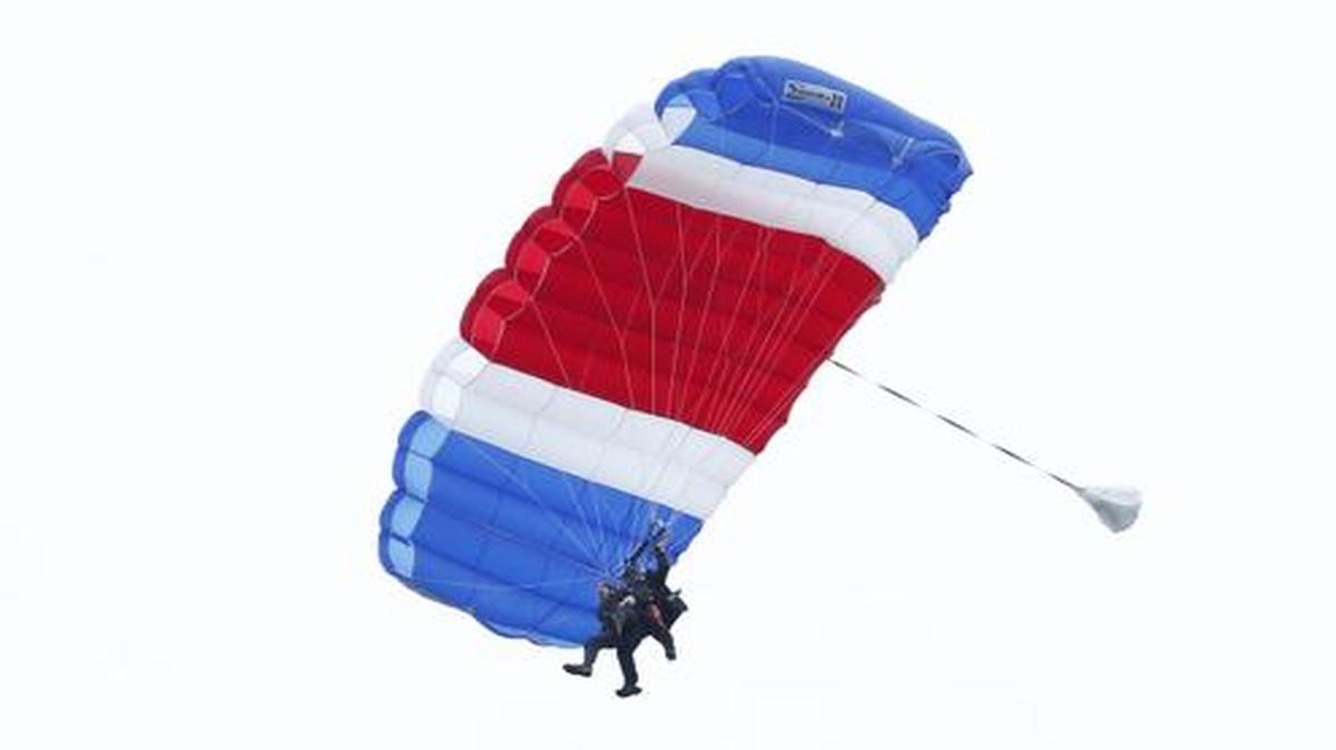 
Former President George H.W. Bush, strapped to Sgt. 1st Class Mike Elliott, a retired member of the Army’s Golden Knights parachute team, floated to the ground during a tandem parachute jump near Bush's summer home in Kennebunkport, Maine, Thursday, June 12, 2014. 
