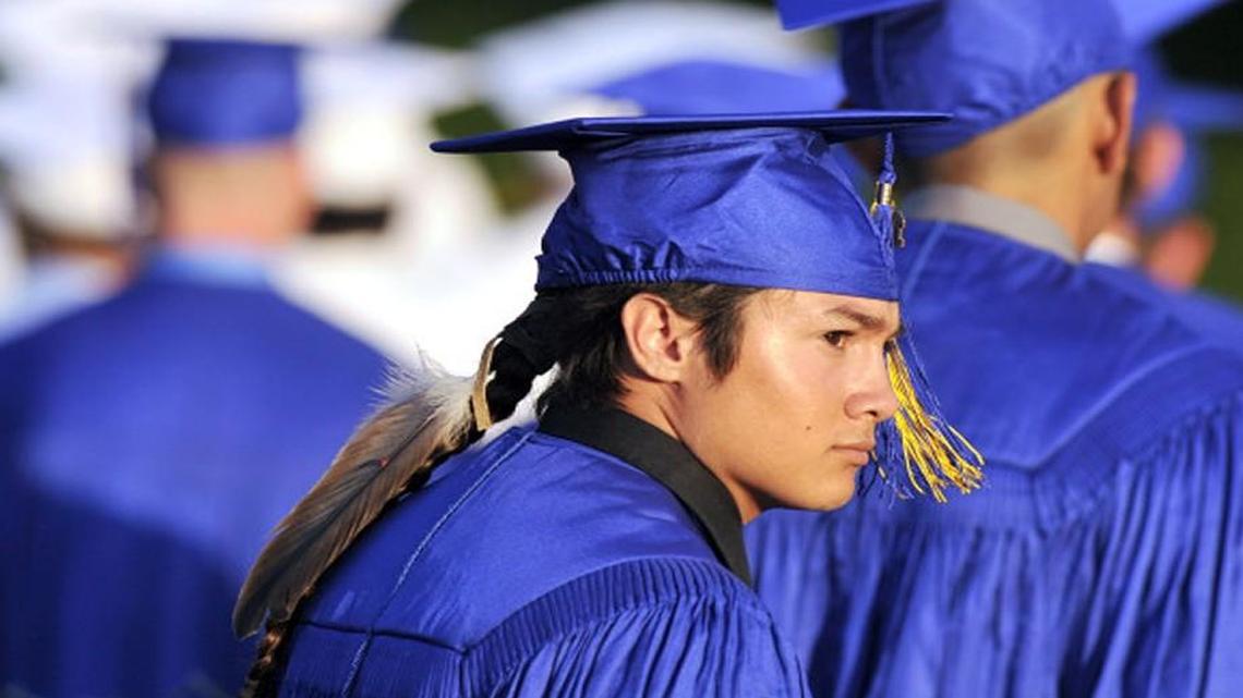 Christian Titman walked into Lamonica Stadium for Clovis High’s graduation ceremony in June, 2015, in Clovis, Calif. The Native American student wore an eagle feather to graduation after resolving a court fight with the school district over the sacred object.