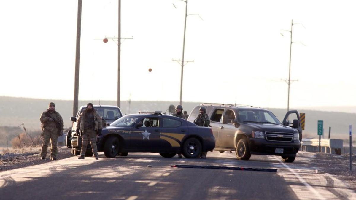 Police officers block the turnout to Sodhouse Lane, which is the main road leading to the Malheur National Wildlife Refuge headquarters, Wednesday, Jan. 27, 2016, near Burns, Ore.