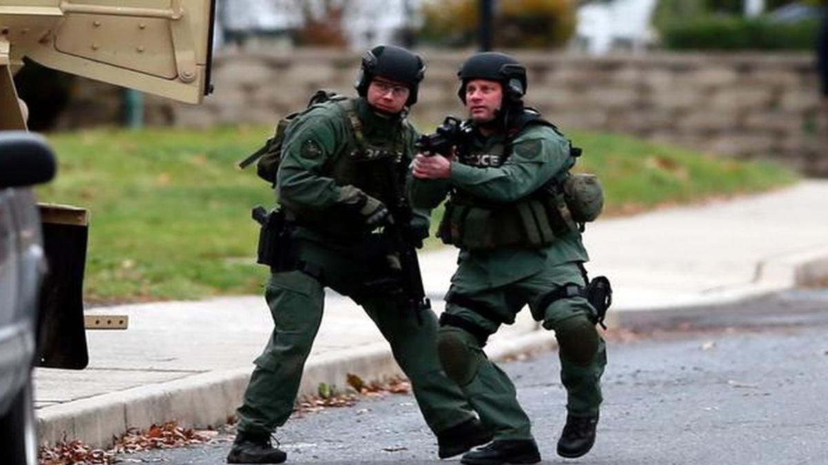 
Police move near the scene of a shooting Monday, Dec. 15, 2014, in Souderton, Pa. 
