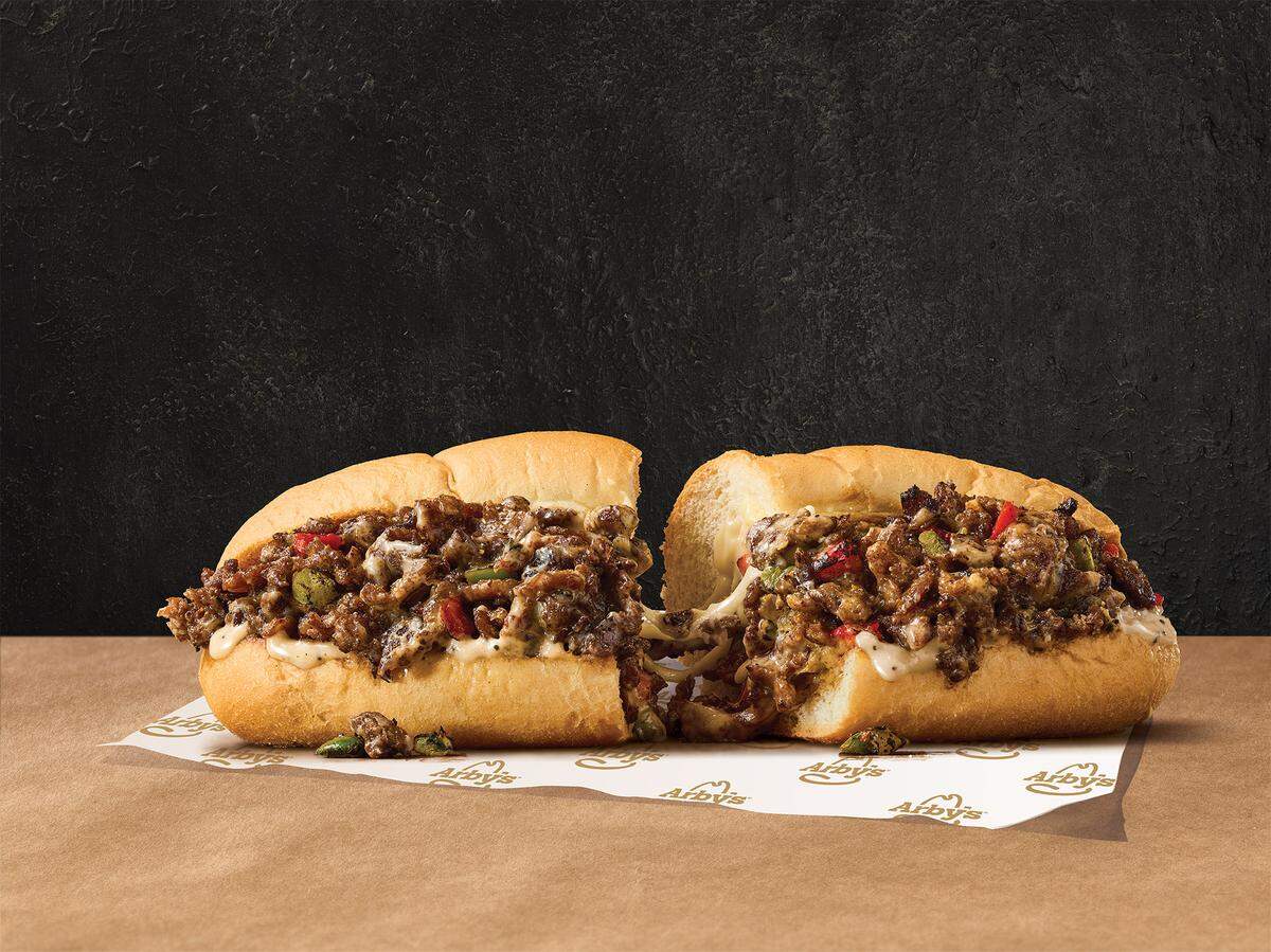 Arby’s new angus cheesesteak is made with thin-sliced angus steak, melted cheese and roasted veggies, the sandwich chains said.