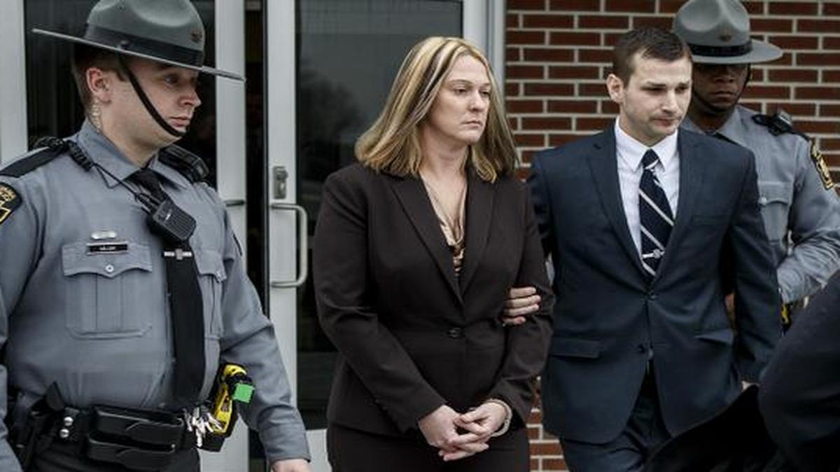 
Lisa J. Mearkle is escorted from District Judge Lowell Witmer's office, in West Hanover Township, Pa., after her preliminary arraignment, Tuesday.
