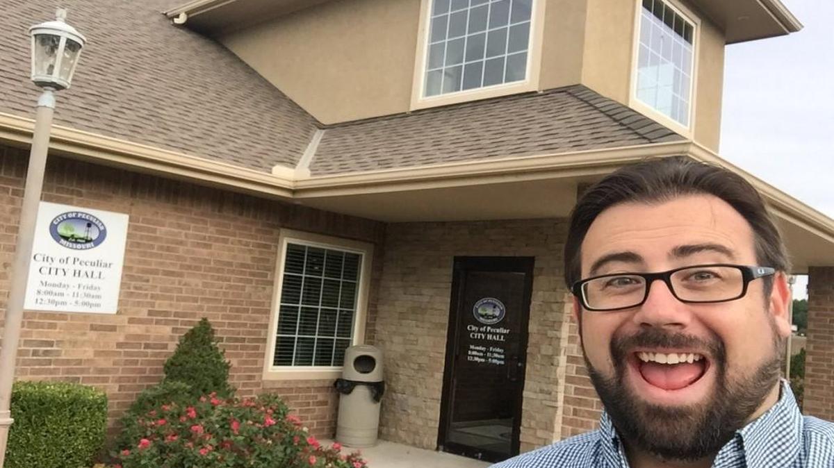Mike Ekey, communications manager and public information officer for the city of Raymore, visited several local city halls on Monday for national #CityHallSelfie day.