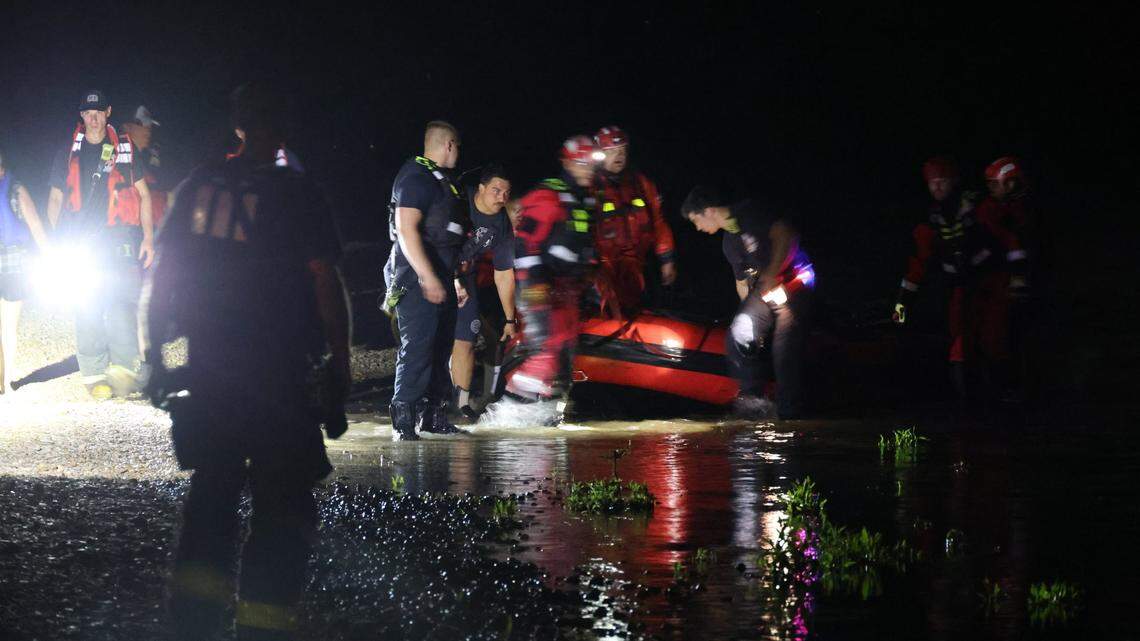 A woman whose boat overturned hung onto a tree branch for two hours before being rescued by Indianapolis firefighters.