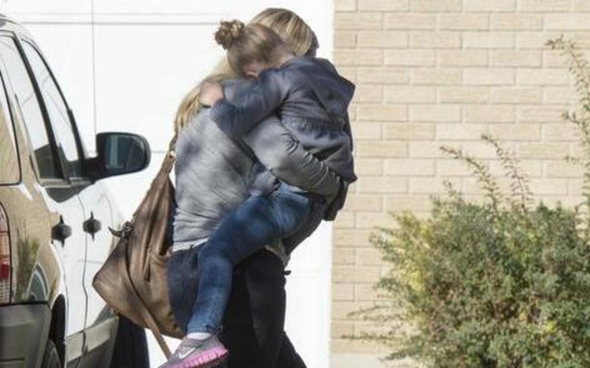 
A Sandy, Utah, family returns home with their daughter after the girl's father rescued her from a man who tried to kidnap her on Friday, Nov. 7, 2014, in Sandy, Utah. 
