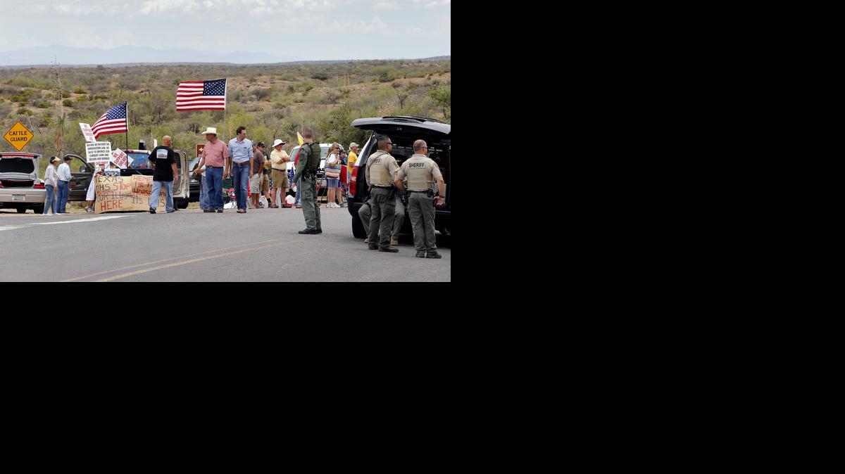 
Protesters gather near the entrance to juvenile facility in an effort to stop a bus load of Central American immigrant children from being delivered to the facility.
