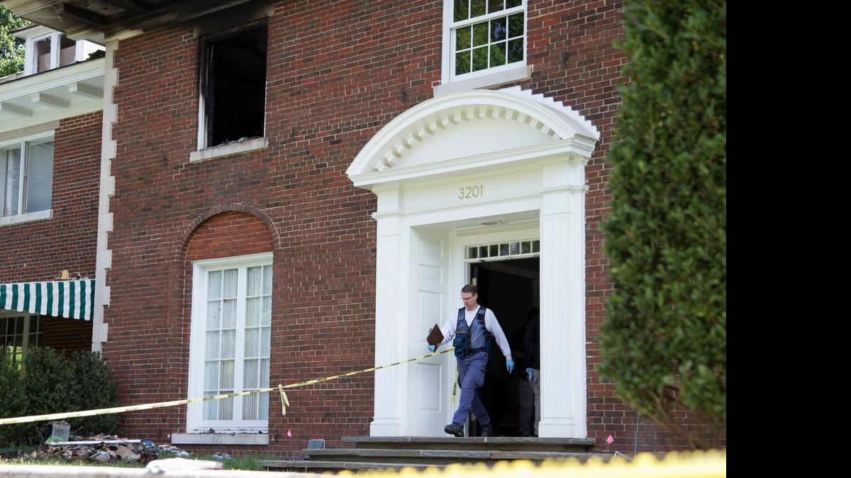 
A Bureau of Alcohol, Tobacco, Firearms and Explosives investigator walks out of the fire-damaged multimillion-dollar home in northwest Washington, D.C.
