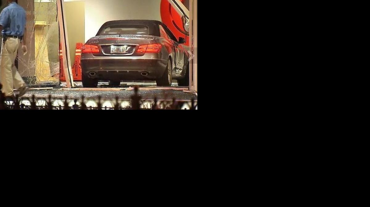 
In this image made from video and released by Myfoxatlanta.com in Atlanta, a man walks near a vehicle that crashed through the lobby entrance of CNN, Friday, June 13, in Atlanta.

