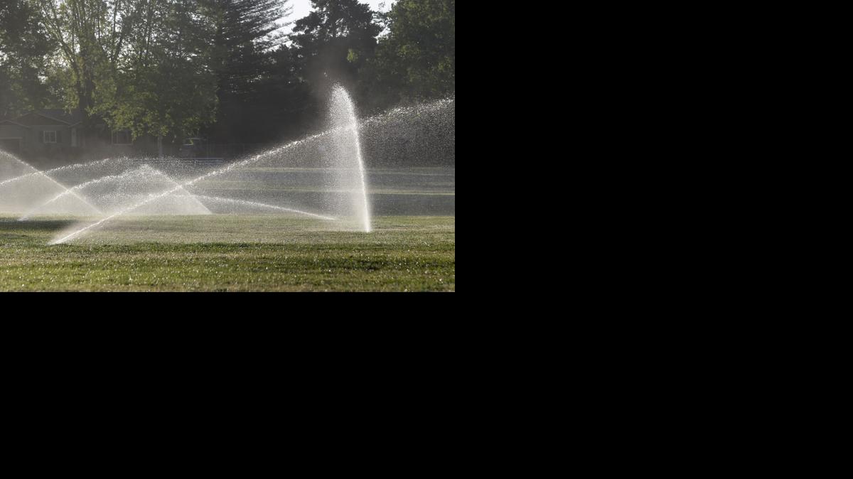 
Sprinklers irrigate the field at a school in Sacramento, California, one day after rains swept through the area
