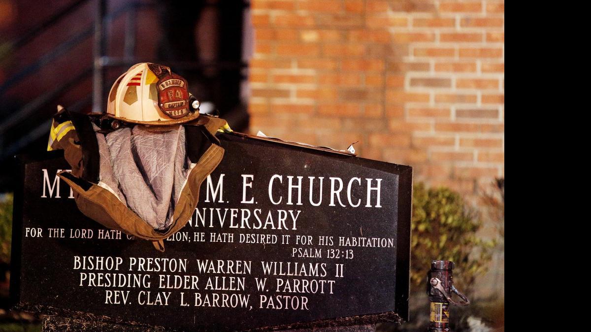 
A firefighter's jacket and helmet sit on a marker outside Mount Zion African Methodist Episcopal church early Wednesday in Greeleyville, S.C. 

