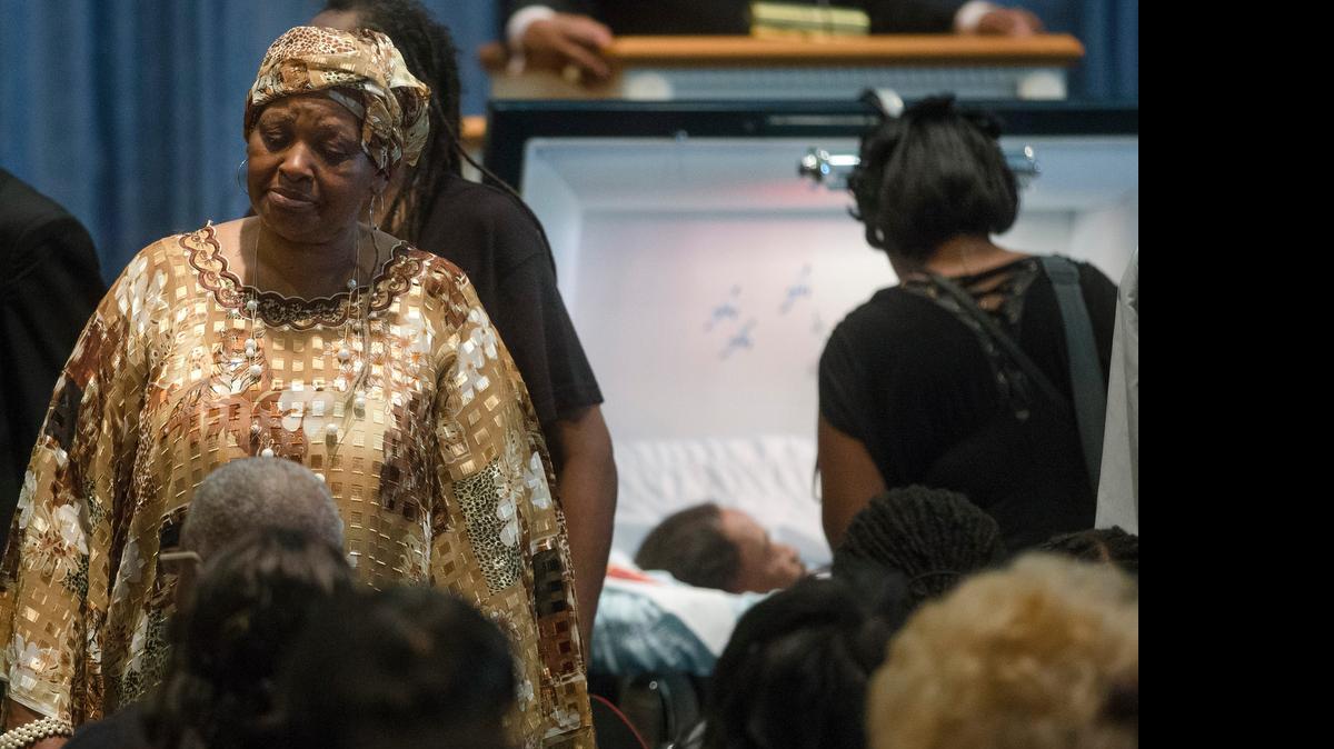 
Audrey Dubose, left, mother of Samuel Dubose, stands near his casket during the funeral in Cincinnati
