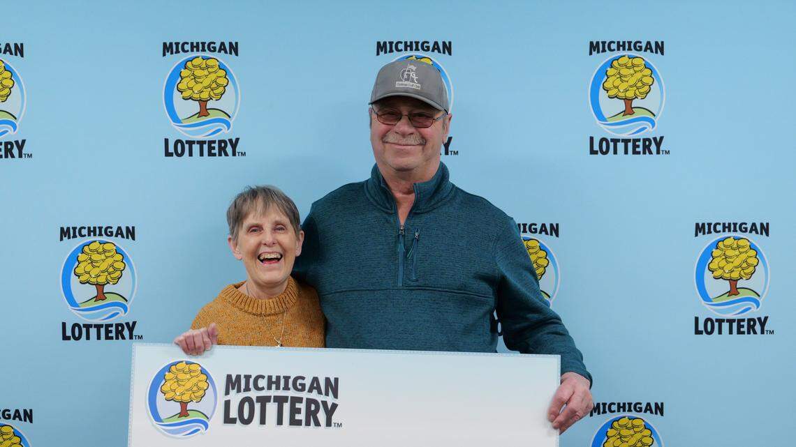 Patricia Royer, 65, receives her lottery winnings from the Michigan Lottery.
