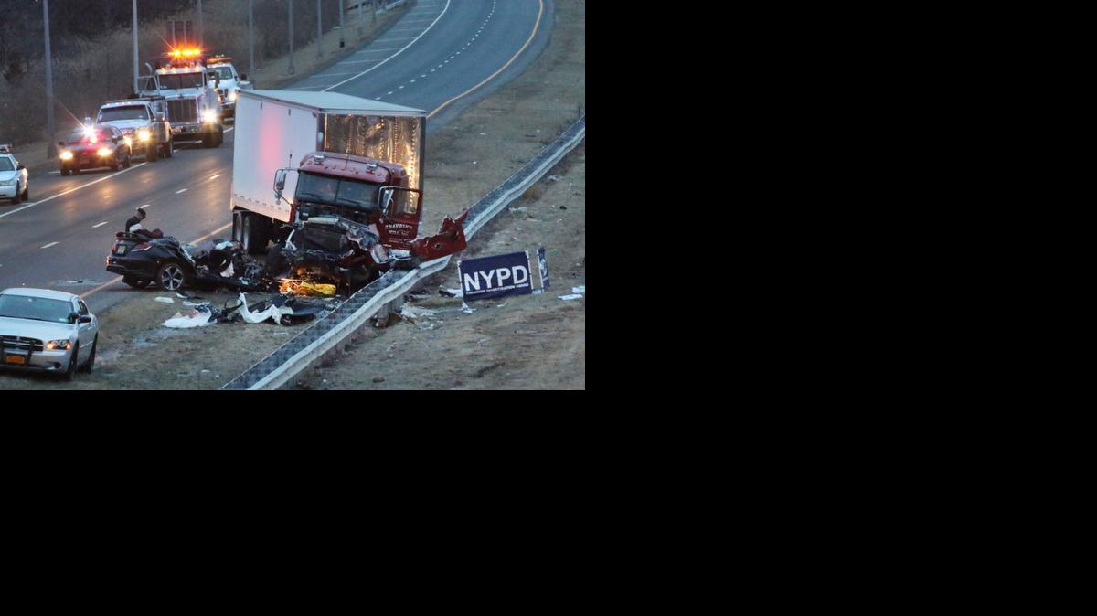 
Police investigate the crash scene between a truck and a car carrying four people in the Staten Island borough of New York, Friday
