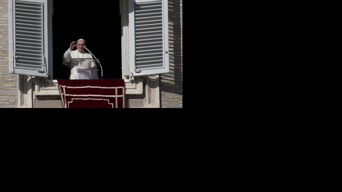 
Pope Francis delivers his blessing during the Angelus noon prayer from his studio's window overlooking St. Peter's Square, at the Vatican, Sunday.
