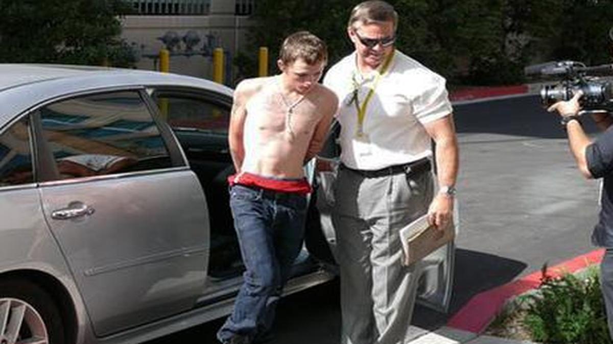
Erich Nowsch, 19, is led from a car to police headquarters for questioning in Las Vegas late last week
