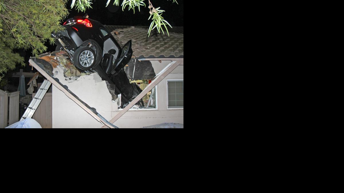 
A sport utility vehicle went airborne and sailed into the roof of this house in Escondido, Calif.
