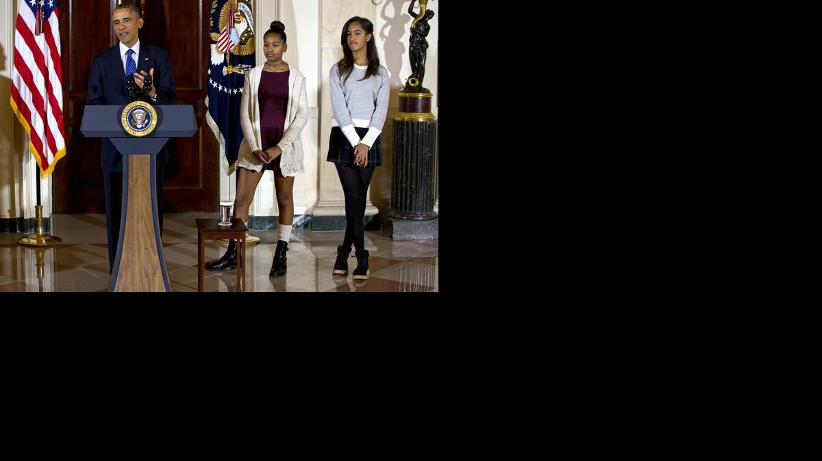 
President Barack Obama, joined by his daughters Malia, right, and Sasha
