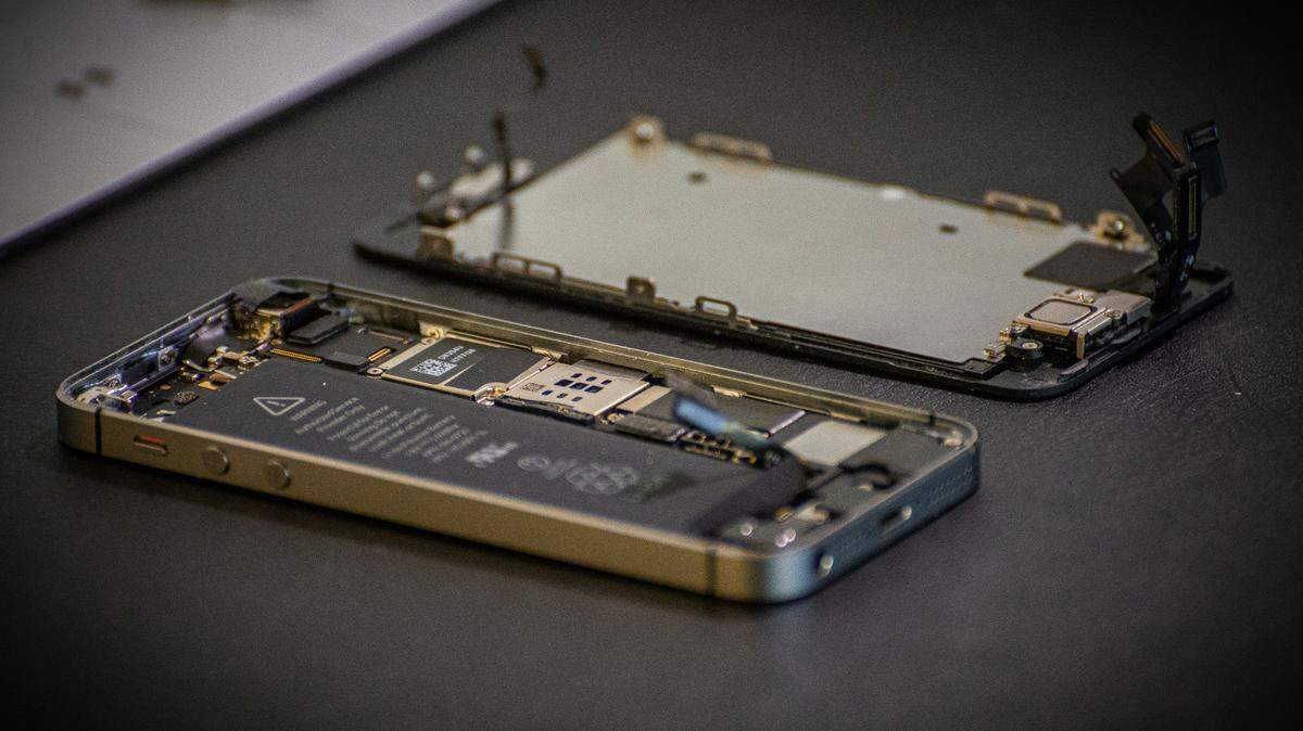 The 27-year-old man secretly downloaded photos off the phones of more than 40 customers, including minors as young as 14, officials said.