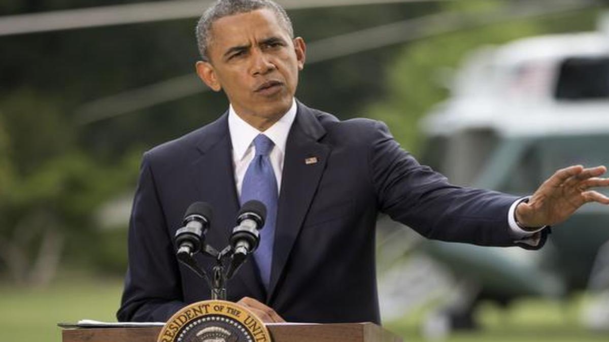 
President Barack Obama talks about his administration's response to a growing insurgency foothold in Iraq, Friday, June 13, 2014, on the South Lawn of the White House 
