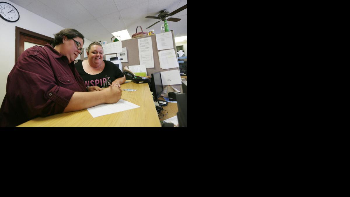 
Jen Kozushko, left, and Aimee McCarter apply for a marriage license inside the Clerk of the District Court office at the Reno County Courthouse in Hutchinson, Kan. The couple was informed later in the day of the application's denial. 
