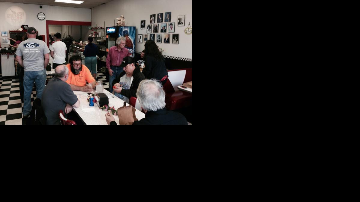
Customers wait for service as Memories Pizza reopened for business Thursday in Walkerton, Ind. 
