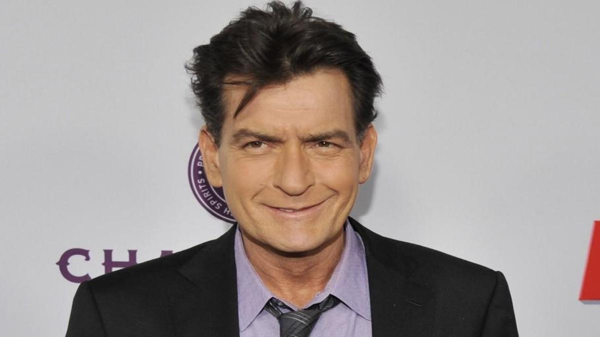 In this April 11, 2013 file photo, Charlie Sheen, a cast member in "Scary Movie V," poses at the Los Angeles premiere of the film. Sheen was sued in Los Angeles Friday, Oct. 3, 2014, by a dental technician who claims the actor punched her in the chest and was abusive during an office visit in late September.