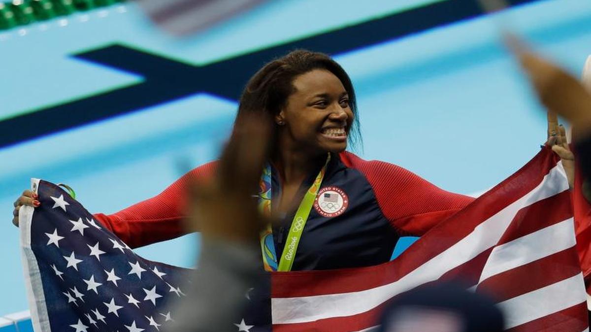 United States' Simone Manuel celebrates winning the gold medal in the women's 100-meter freestyle during the swimming competitions at the 2016 Summer Olympics.