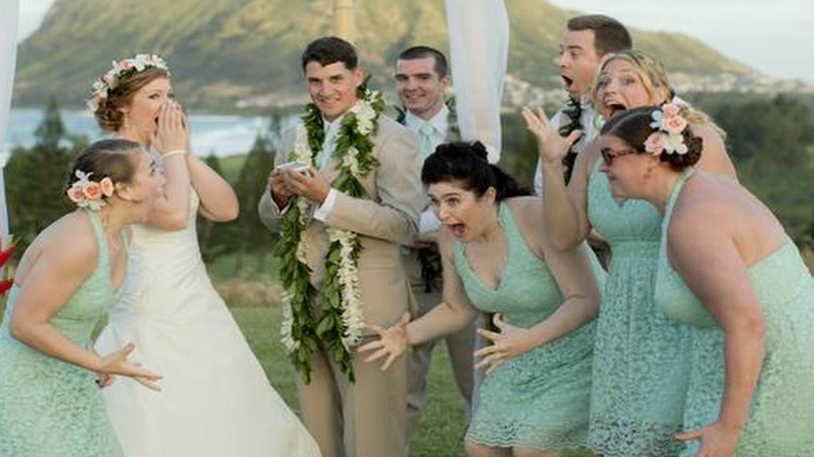 
Natalie Heimel, second from left, and Edward Mallue Jr., third from left, both U.S. Army captains stationed in Hawaii, reacting with their wedding party while getting a phone call from President Obama during their ceremony.
