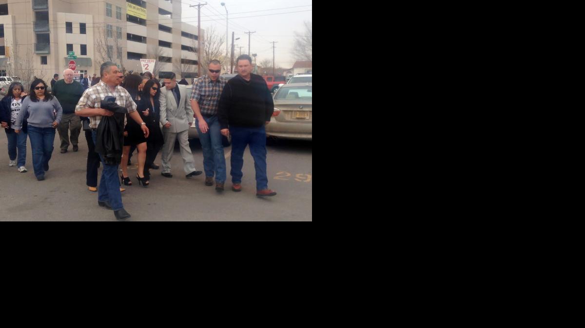 
Rep. Debbie Rodella, D-Espanola, the wife of former Rio Arriba County Sheriff Thomas Rodella, center, wearing sunglasses, is helped from the federal courthouse as family members and supporters leave
